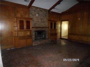 Change floors, update fireplace, and paint wood paneling. 